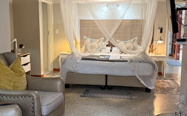 elegant suite where a canopy bed meets refined, cozy seating. The tasteful design and warm ambiance create a welcoming retreat for ultimate relaxation. elegant suite where a canopy bed meets refined, cozy seating. The tasteful design and warm ambiance create a welcoming retreat for ultimate relaxation.