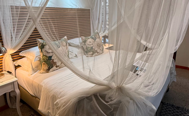 romantic safari suite, canopy bed with netting, cozy lodge retreat, elegant bush accommodation, intimate safari stay, stylish bedroom design, tranquil escape, comfortable safari lodging