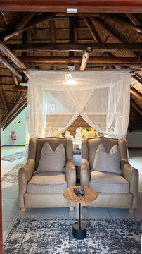 Kruger Riverside Lodge, Marloth Park, DCC Hotel Group, loft suite, canopy bed, cozy lounge chairs, safari hideaway, boutique retreat