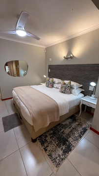 modern safari bedroom, stylish lodge interior, king-size comfort, cozy retreat, elegant bush accommodation, intimate safari lodging, tranquil stay, comfortable safari suite
