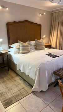 Kruger Riverside Lodge, Marloth Park, DCC Hotel Group, luxury bedroom, king-size bed, warm lodge interior, comfortable retreat, elegant furnishings