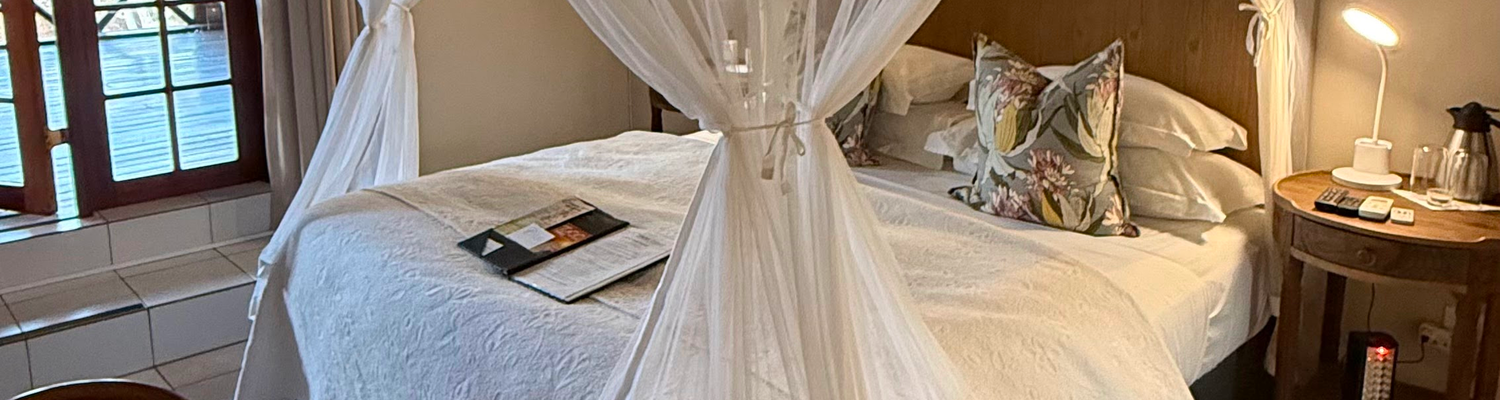 Kruger Riverside Lodge, Marloth Park, DCC Hotel Group, canopy bed, cozy safari bedroom, stylish interiors