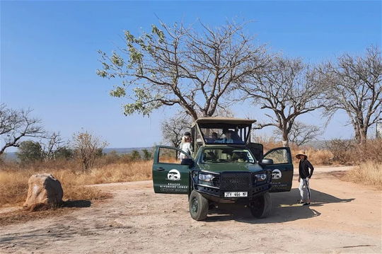 Vehicles on stand by while guests stretch their legs and enjoy the landscape. Kruger Park Open Vehicle Safaris, Marloth Park. DCC Hotel Group