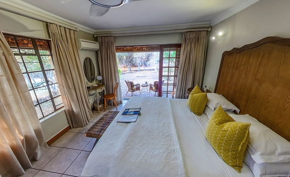 Private patio with tranquil views. Elegant furnishings and soft natural light with a view on the South African bush.