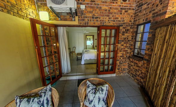 Private patio offers a seamless flow between indoor comfort and outdoor charm. Guests can relax in cozy seating while enjoying the warm ambiance of the lodge’s tranquil setting.