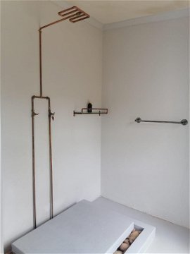 The bathroom features a shower and a bath tub