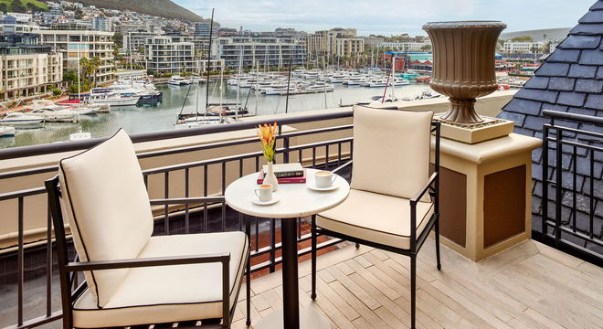 Enjoy stunning views from our elegant balcony, where you can unwind with a cup of coffee surrounded by stylish furniture.