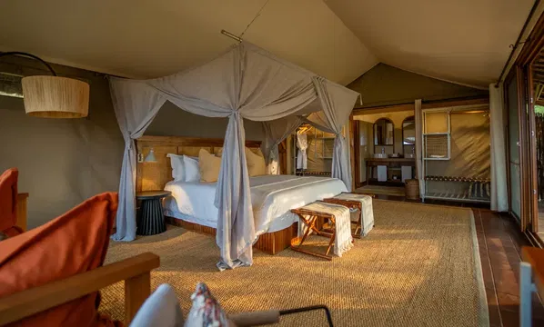 At SIMBAVATI Grumeti, unwind in a cozy bedroom with calming decor, offering a perfect retreat for relaxation.