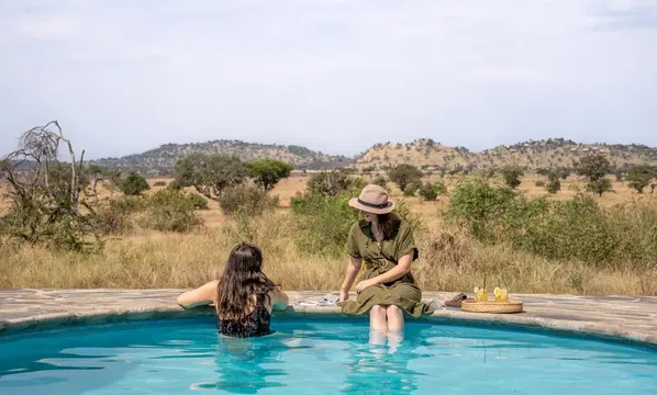 Relax in the serene pool at SIMBAVATI Grumeti, where clear waters and bright skies create a perfect escape.