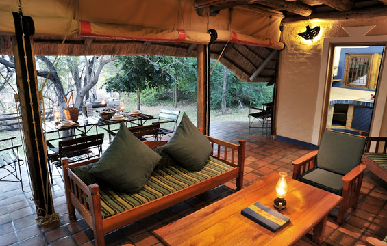 Unwind in style at Victoria Falls Safari Club, where a beautiful living room and spacious patio offer the perfect blend of luxury and nature.