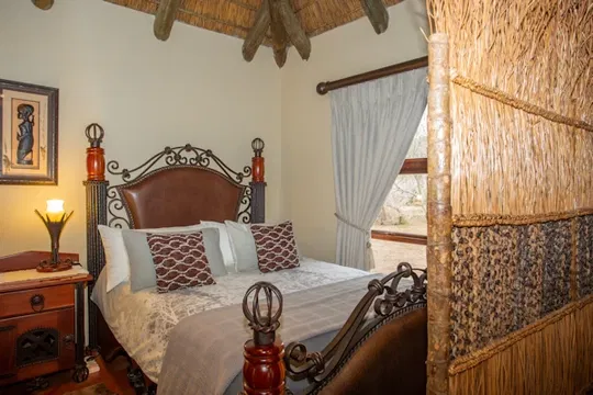 Escape to Indalu Game Reserve, where luxury meets nature. Relax in a beautifully appointed suite with plush linens, a cozy four-poster bed, and a serene atmosphere for the perfect retreat.