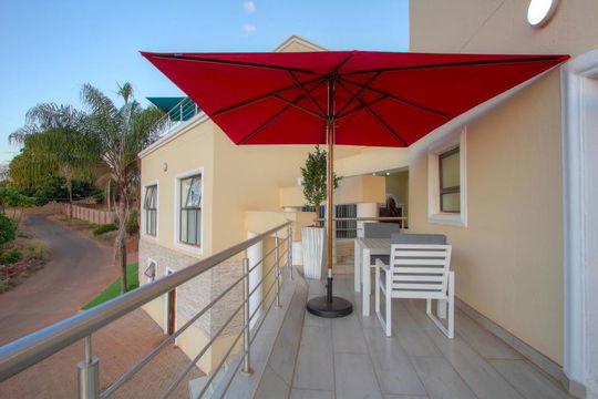 Experience the ultimate in relaxation at Royal Hills Lodge and Spa! Our inviting patio, featuring a red umbrella for shade, provides the perfect space to soak in nature’s beauty and unwind. Embrace comfort and luxury in every moment. Book your getaway now!