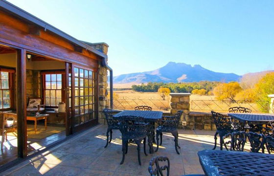 Relax in the peaceful ambiance of Moolmanshoek, where an inviting patio offers a serene escape surrounded by breathtaking mountain views.