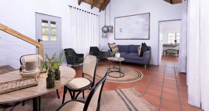 Simbavati Mvubu Cottage offers a cozy living space, perfect for relaxation with its comfortable couch, coffee table, and calming décor.