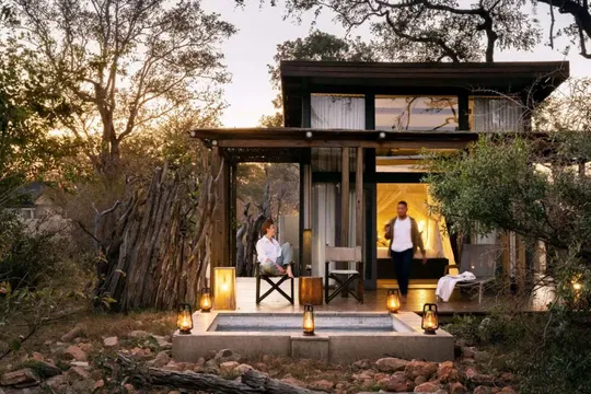 Savour a cosy and welcoming outdoor environment at Simbavati River Lodge, where a roaring fire and the surrounding landscape create a tranquil haven.