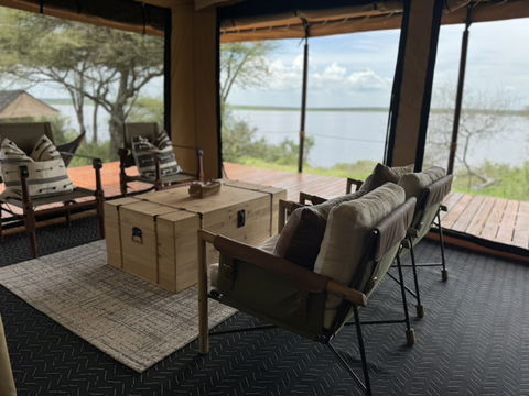 Relax in a cozy, inviting space where rustic wooden furniture blends seamlessly with the natural surroundings, offering a comfortable and peaceful retreat.