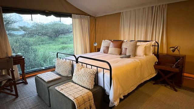Relax in a cozy, inviting bedroom where soft bedding and natural light create a peaceful retreat, offering the perfect setting for relaxation.