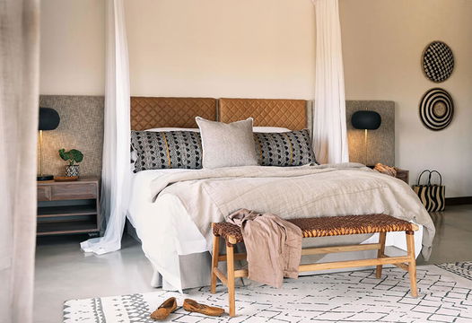 Simbavati Homestead offers a comfortable and welcoming bedroom, perfect for relaxation after a day in nature.
