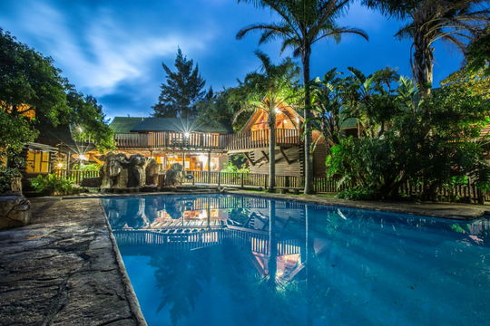 Relax in style at Moolmanshoek, where a serene swimming pool nestled among lush trees offers the perfect spot to unwind and soak in nature's beauty.