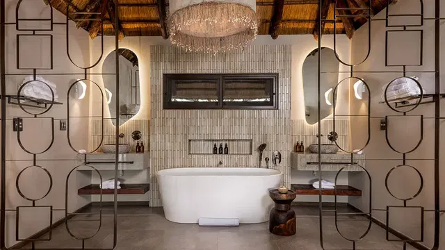 At Simbavati Waterside, enjoy bathrooms that combine functionality and comfort, offering a perfect space to unwind with high-end fixtures and finishes.