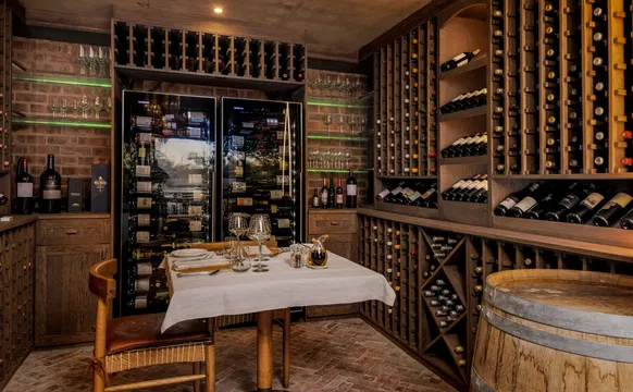 Indulge in a refined wine experience at Simbavati Waterside, where the cozy wine cellar invites you to unwind and enjoy your favorite bottles.