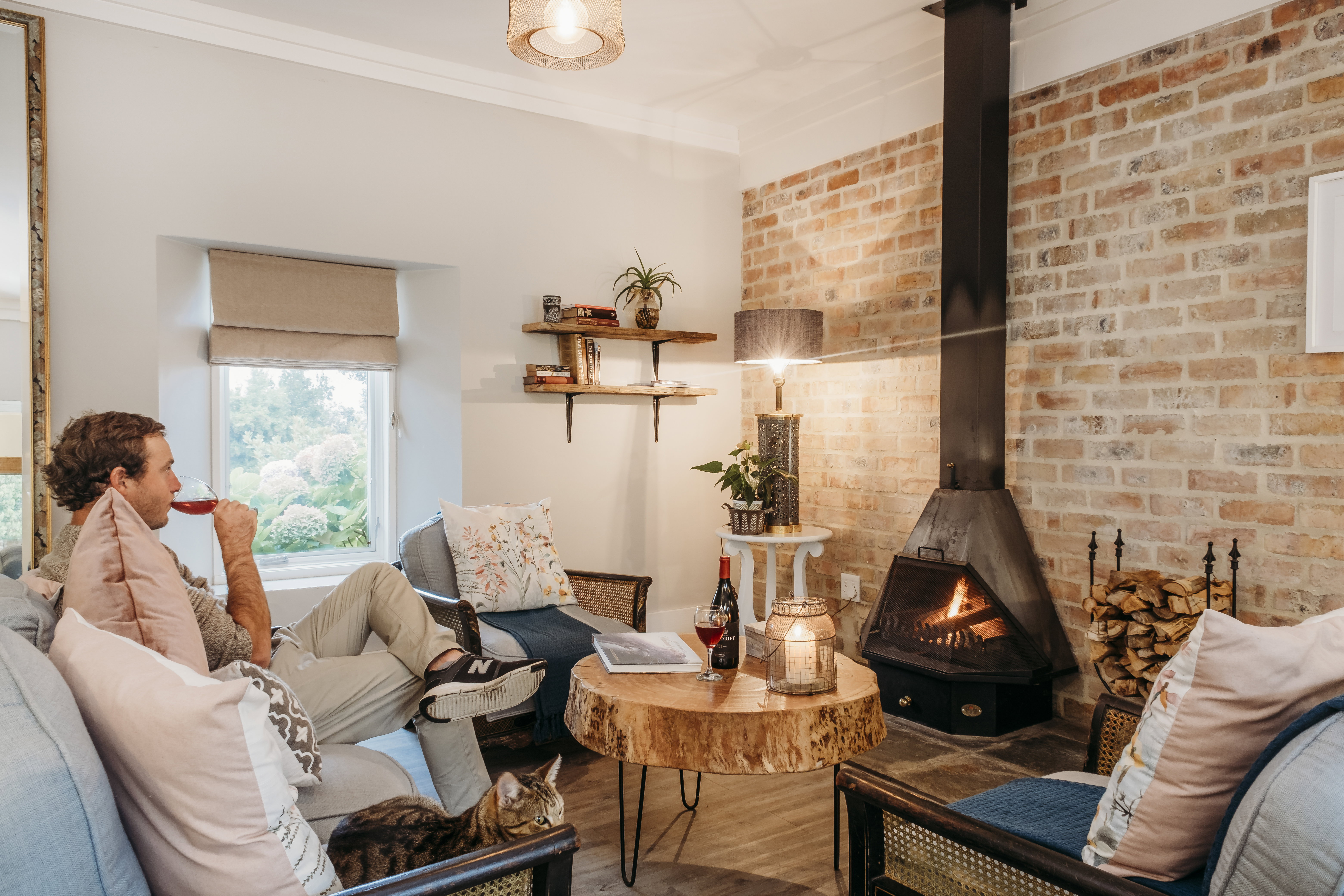 a warm cozy lounge, sipping red wine in front of a fire on a winters getaway to White Water Farm 