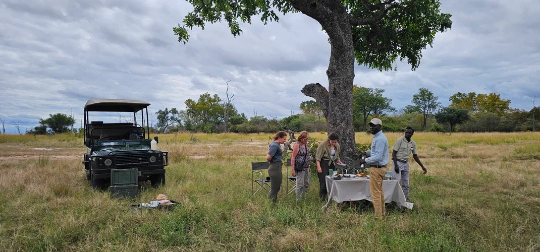 Guests having a safari Lunch in the bush in South luangwa National during a whole day game drive with Msandile River Lodge