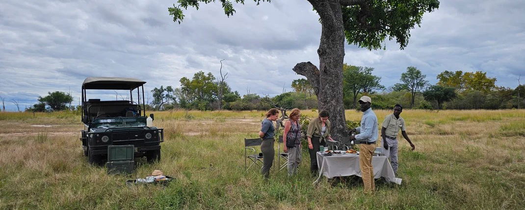 Guests having a safari Lunch in the bush in South luangwa National during a whole day game drive with Msandile River Lodge