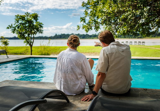 couple enjoying the pool at msandile river lodge in nsefu zambia