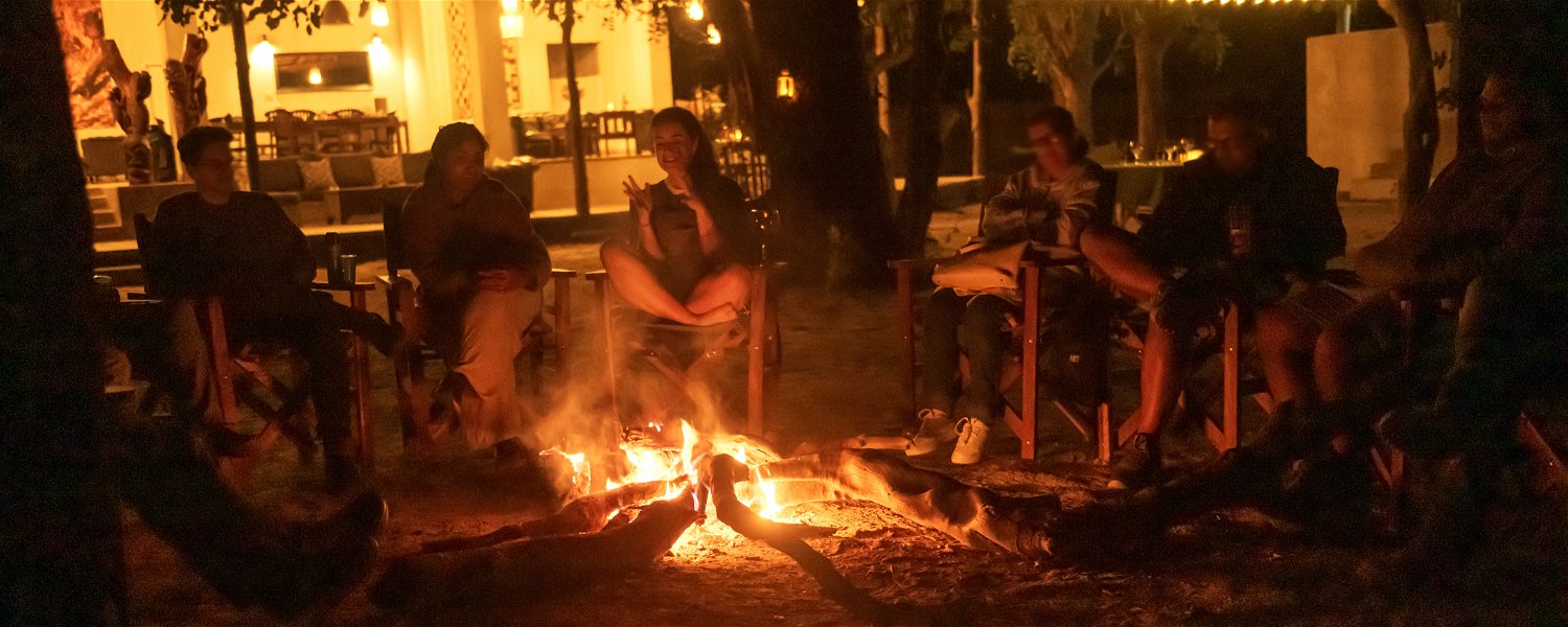 Telling stories at the fire at night at Msandile River Lodge