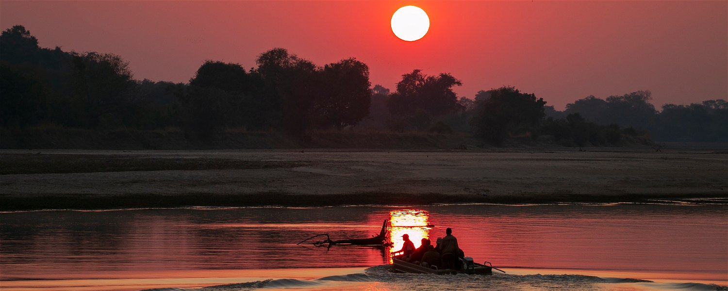 Starting the game drive in a boat in the sunrise