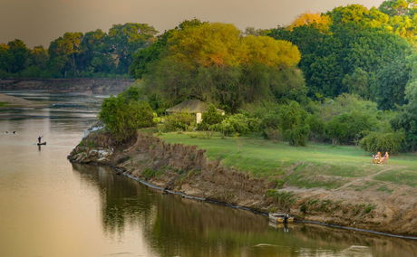 people chilling on the riverbank @msandileriverlodge