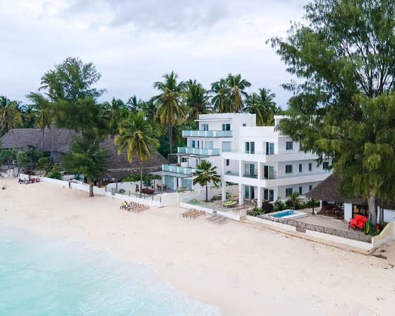Imani Penthouse Apartment Complex (on left) - The top floor penthouse is situated directly on the beach for easy access to the turquoise ocean.