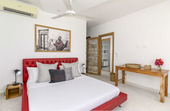 The sea-facing bedrooms feature large king-sized beds with overhead ceiling fans, ensuring a restful nights sleep in paradise.