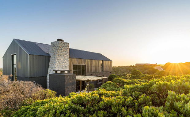 Scenic view of Black Barn in Romansbaai, a luxury coastal stay surrounded by fynbos, ocean views, peaceful landscapes, and modern architecture.