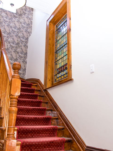 Original staircase with imported mosaic window