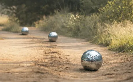 Game of boule played on a sandy road in Thornybush Game Reserve