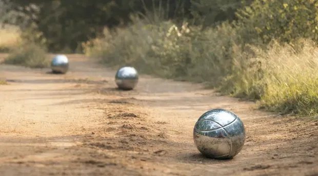 Game of boule played on a sandy road in Thornybush Game Reserve
