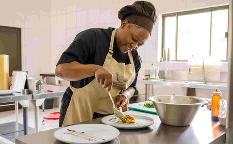 Shimungwe lodge chef at work in her kitchen preparing meals for guests at the lodge in the Greater Kruger