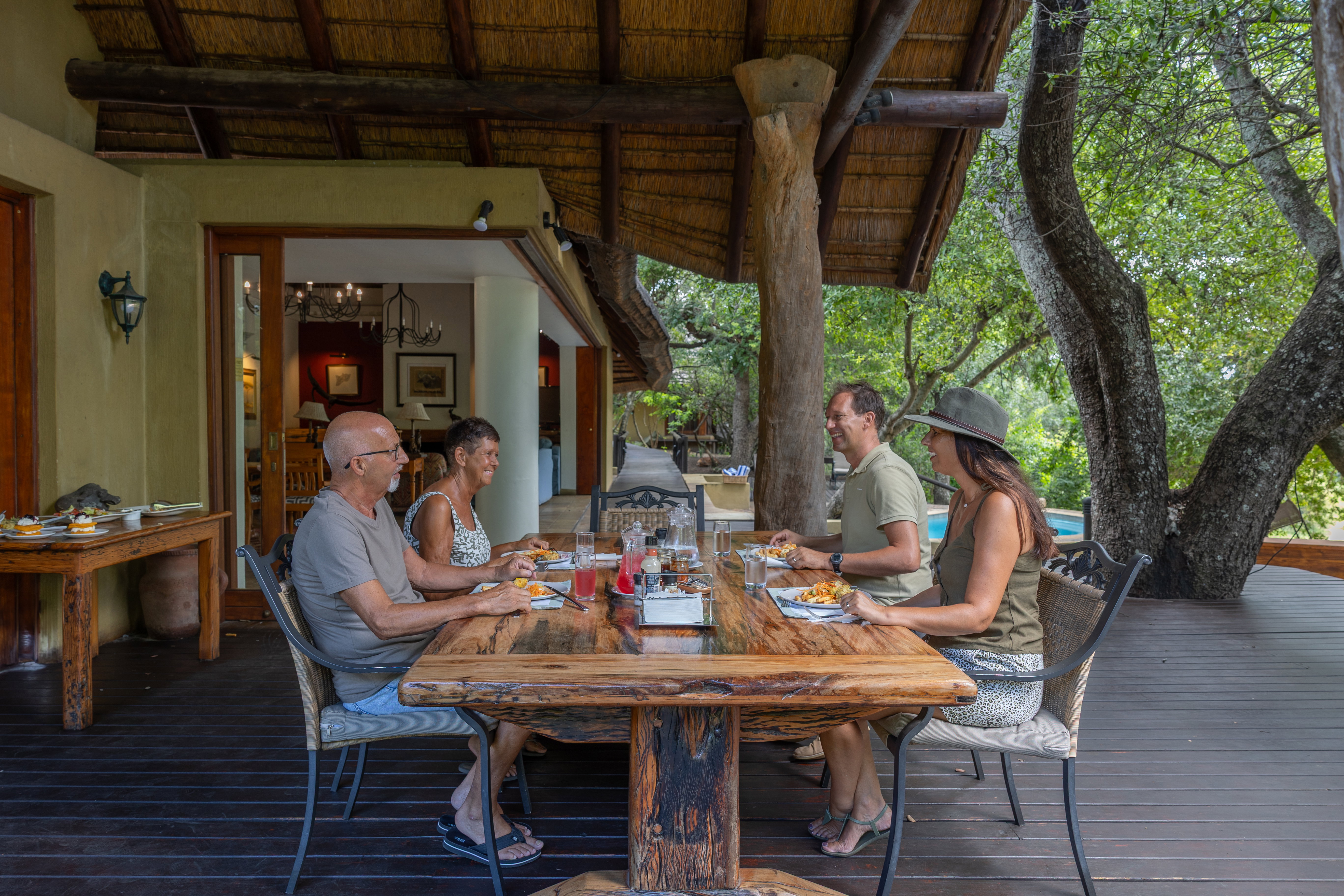 Family enjoying a meal at luxury safari Shimungwe Lodge, Thornybush Game Reserve, Greater Kruger