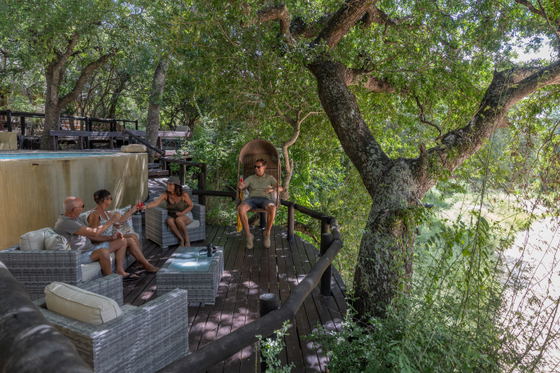 Family relaxing and enjoying each other's company on the deck at Shimungwe Lodge, Thornybush Game Reserve, Greater Kruger Family relaxing and enjoying each other's company on the deck at Shimungwe Lodge, Thornybush Game Reserve, Greater Kruger
