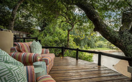 Watch animals in the riverbed from lounge chairs at a small luxury safari lodge. Thornybush Game Reserve, Greater Kruger