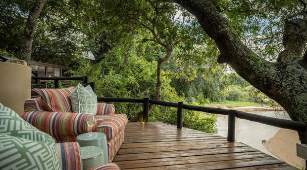 Watch animals in the riverbed from lounge chairs at a small luxury safari lodge. Thornybush Game Reserve, Greater Kruger