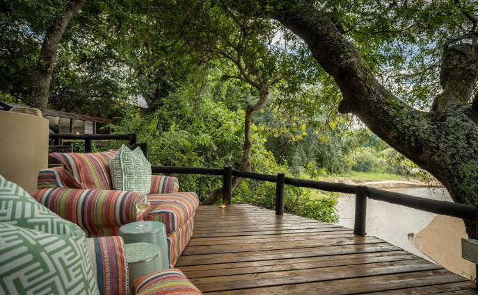 Watch animals in the riverbed from lounge chairs at a small luxury safari lodge. Thornybush Game Reserve, Greater Kruger