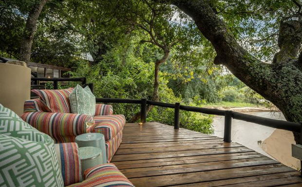 Watch animals in the riverbed from lounge chairs at a small luxury safari lodge. Thornybush Game Reserve, Greater Kruger