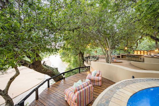 Comfortable view over Timabavati riverbed looking for big five on safari in Thornybush