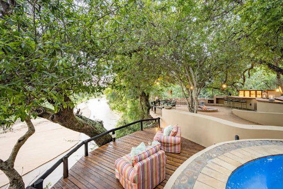 Comfortable view over Timabavati riverbed looking for big five on safari in Thornybush