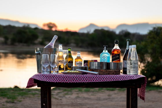 Sundowner drinks to be enjoyed watching the waterhole as the sun sets, Thornybush Game Reserve, Greater Kruger Sundowner drinks to be enjoyed watching the waterhole as the sun sets, Thornybush Game Reserve, Greater Kruger
