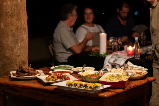 Guests enjoying dinner in the evening, Shimungwe Lodge, Thornybush Game Reserve, Greater Kruger Guests enjoying dinner in the evening, Shimungwe Lodge, Thornybush Game Reserve, Greater Kruger