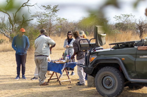 Family stopped for coffee while on a morning game drive, Thornybush Game Reserve Family stopped for coffee while on a morning game drive, Thornybush Game Reserve